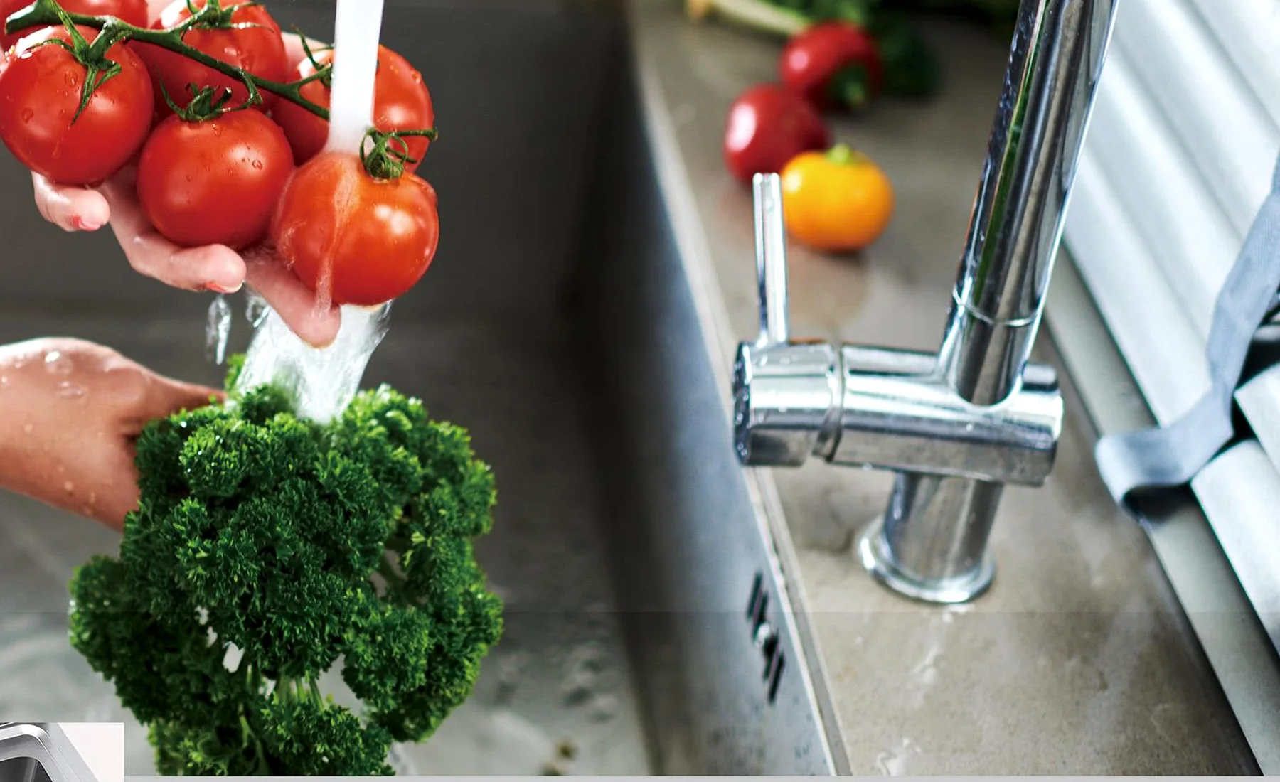 Fresh vegetables being washed in a commercial stainless-steel sink